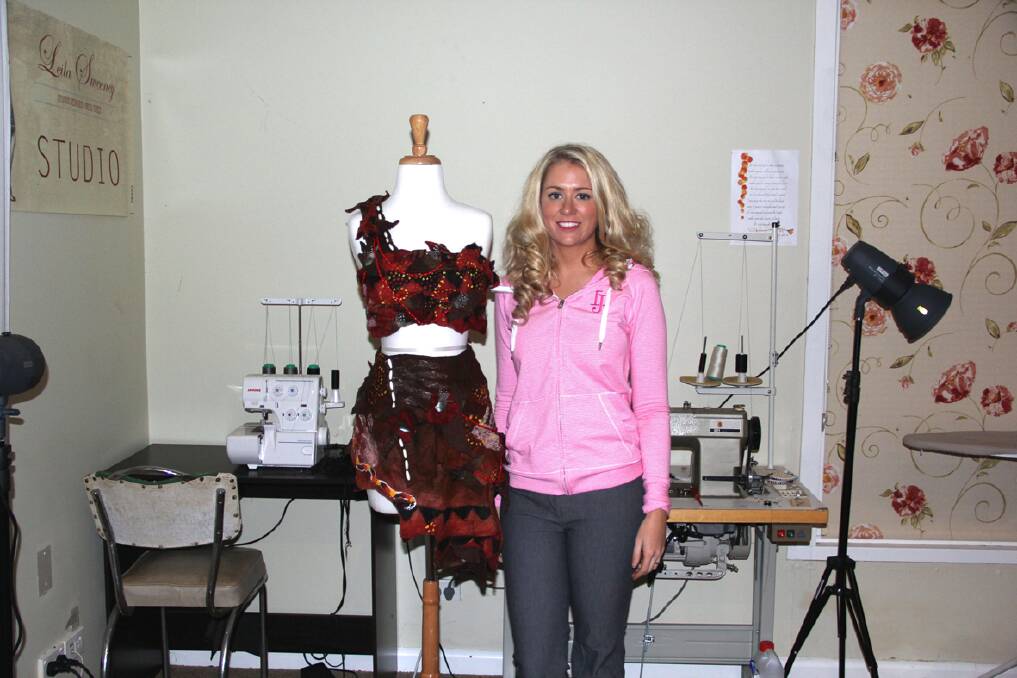 Leila Sweeney at home in her studio with the costume worn by the Miss Humanity Australia entrant in Barbados.