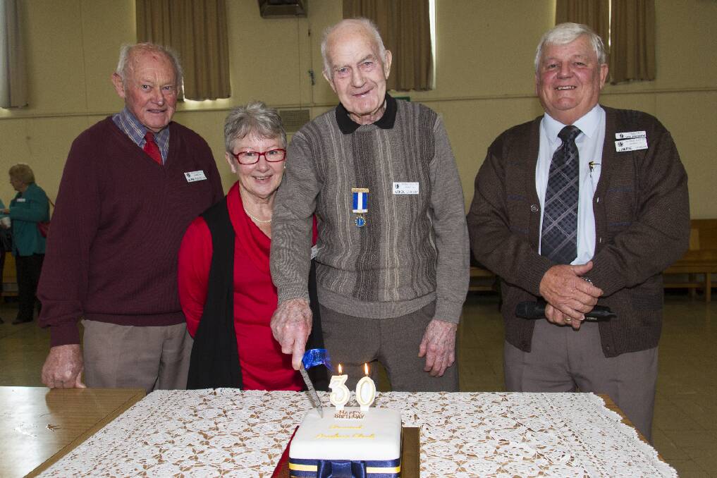 Probus life member Athol Graham had the honour of cutting the birthday cake with George Robertson, Anne Shalders and Lawrie Tonkin. Picture: PETER PICKERING