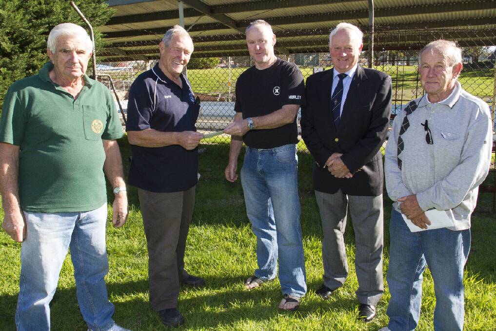 Ambrose Cashin, from the Ararat Olympic Swimming Pool Committee, centre, accepts a donation from the Ararat Woodies Lew Day and Dave Mitchell (left) and Ararat Legacy s John McRae and Alan Wilson.  Picture: PETER PICKERING