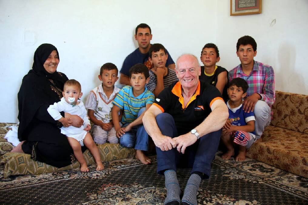 Tim Costello sits with refugees in Jordan. Picture: Stephen Levitt for WVA