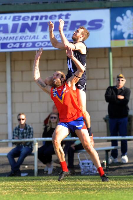 Ararat high flyer Beau Cosson leaps onto the shoulders of Bellarine opponent Daniel Sturzaker during Saturday s WorkSafe Country Championship clash. Cosson bagged five goals for the Wimmera to guide the team to a 17-point victory and was named the Big W s best player. Picture: PAUL CARRACHER