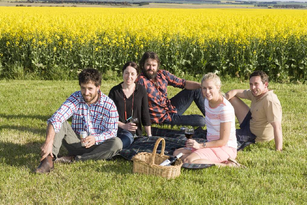 Sean McDougall, Renee Walls, Mick Morgan, Leila McDougall and Tim Barr in the middle of a canola crop discussing Mellow in the Yellow.  
 Picture: PETER PICKERING