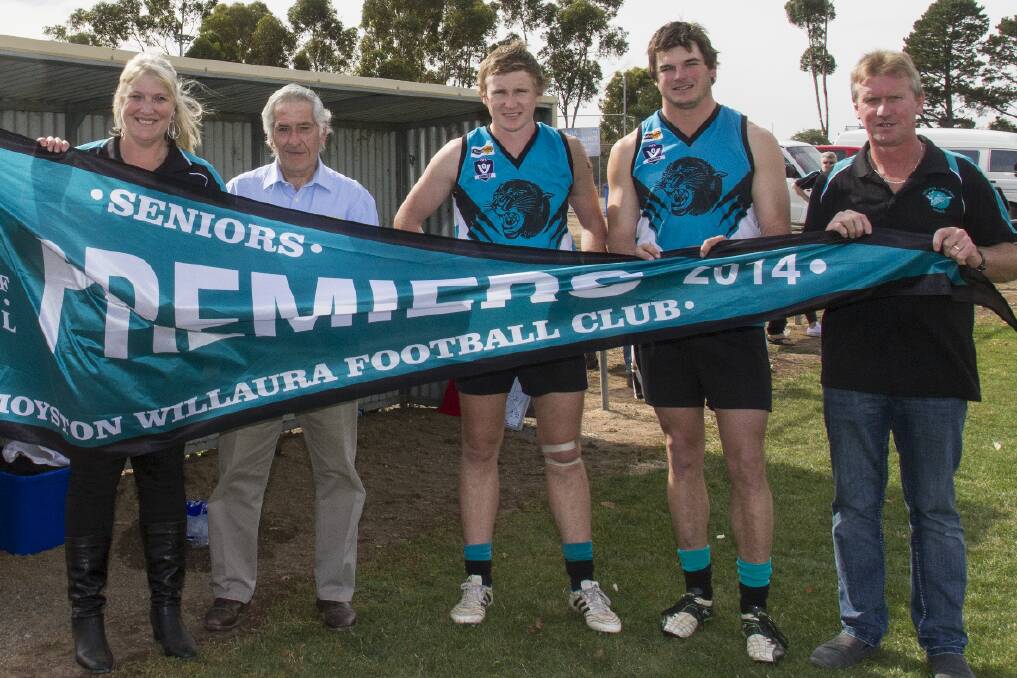 PUMA PRIDE: Moyston/Willaura Football-Netball Club president Cheryle Stapleton, Mininera and District Football League chairman David Watson, premiership captains Matt Peel and Lynden Brewis and gameday coach Dennis Bell unfurl the club's 2014 senior premiership flag at the weekend. Pictures: PETER PICKERING