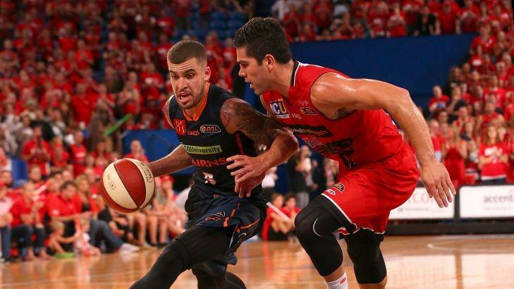 Talisman: Cairns guard Scottie Wilbekin drives to the basket against Perth defender Drake U'u during game two of the NBL semi-finals series between the Wildcats and the Taipans at Perth Arena. Photo: Paul Kane