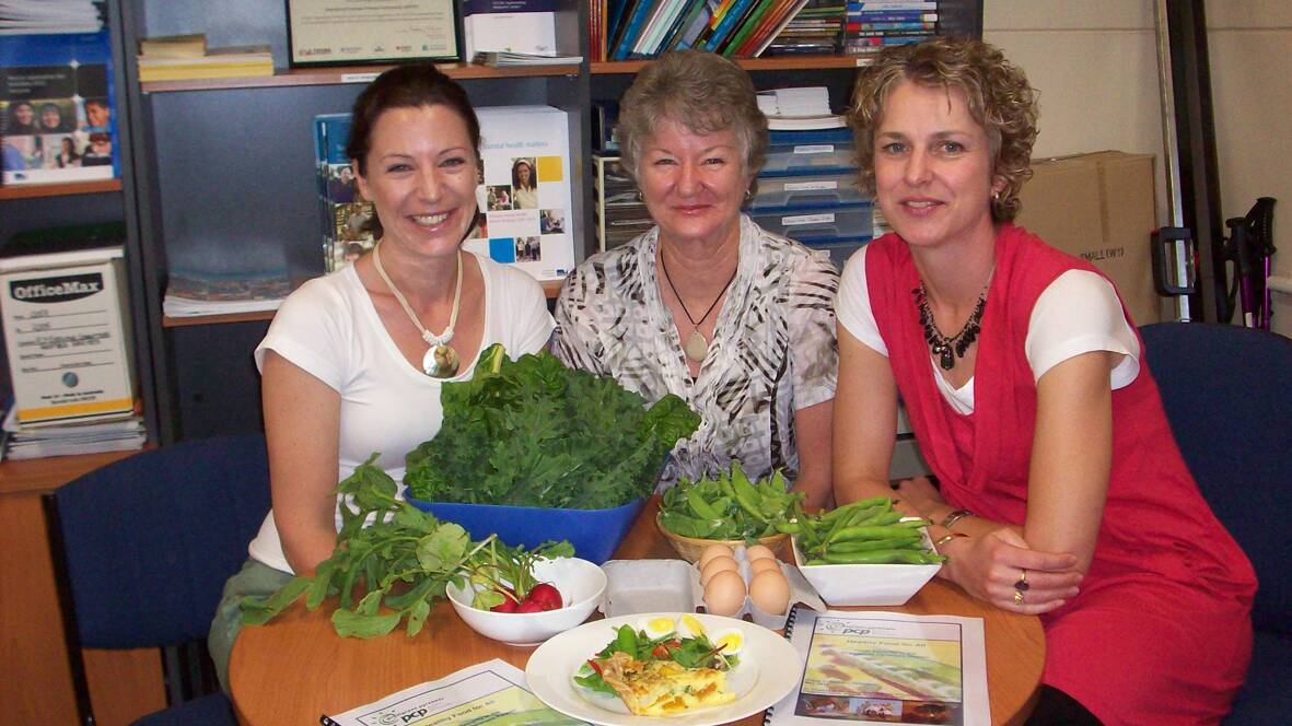Emily Anderson, Meagan Ward and Marlene Goudie preparing for the Food for All forum.