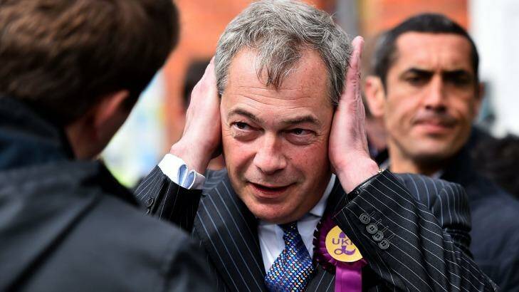 UKIP leader Nigel Farage covers his ears as he campaigns in Ramsgate in south east England on on Wednesday. Photo: Ben Stansall