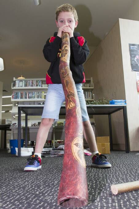 The Ararat Regional Library celebrated NAIDOC Week with a visit to the library by Brambuk, introducing visitors to aboriginal customs and stories. Ashton was one visitor who tried the didgeridoo on for size.  
 Picture: PETER PICKERING
