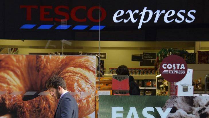 A customer passes a branch of the Tesco Express convenience store in central London.  Photo: Toby Melville