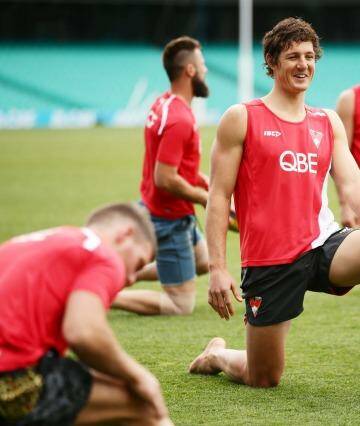 Bend, don't break: Kurt Tippett (centre) at a Swans recovery session. Photo: Matt King/Getty Images