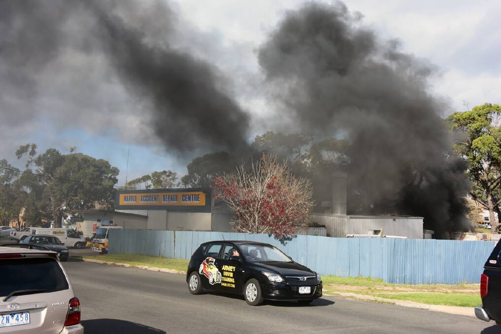 A plume of black smoke could be seen from the rear of Ararat business Harris Accident Repair Centre on Tuesday afternoon. Pictures: SAM SHALDERS