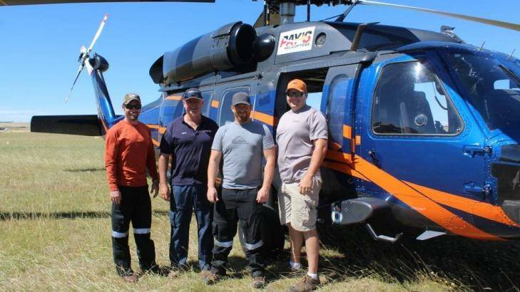 Brandon Hahaj, Fergus Frater, Brian Jorgenson and Brady Schaures stand in front of the UH60A Black Hawk at Goulburn airport, on standby to assist the fire in Tarago.  Photo: Mariam Koslay