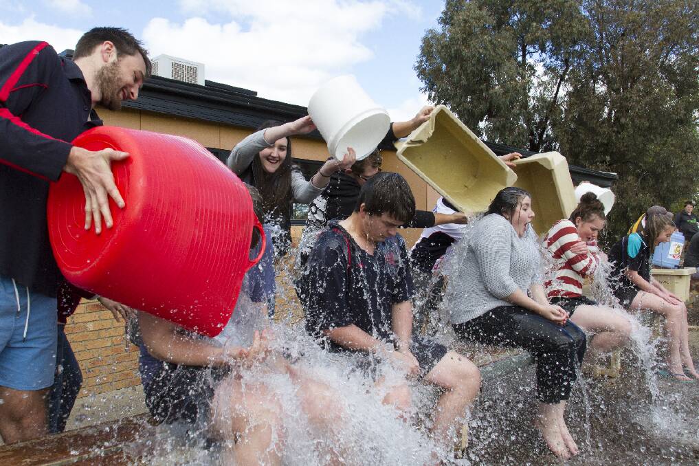 With the teachers raising the most amount of money for Motor Neurone Disease research they got to douse the students in ice water. Pictured are Matt Miller, Jenny, and Luke Rudolph dousing Brad, Joel, Toni, Sam and Naomi. Picture: PETER PICKERING