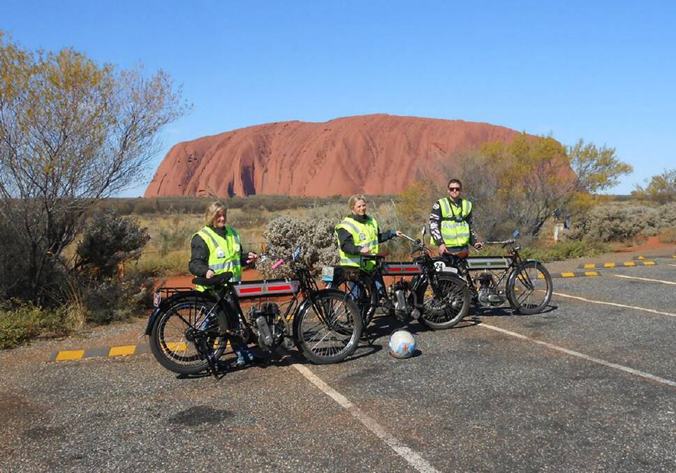 Jodie Thompson, Amanda Mahncke and Daniel Sargent at the iconic Uluru with their iconic vintage motor bikes on the way to Darwin in the Adelaide to Darwin Vintage Rally.
