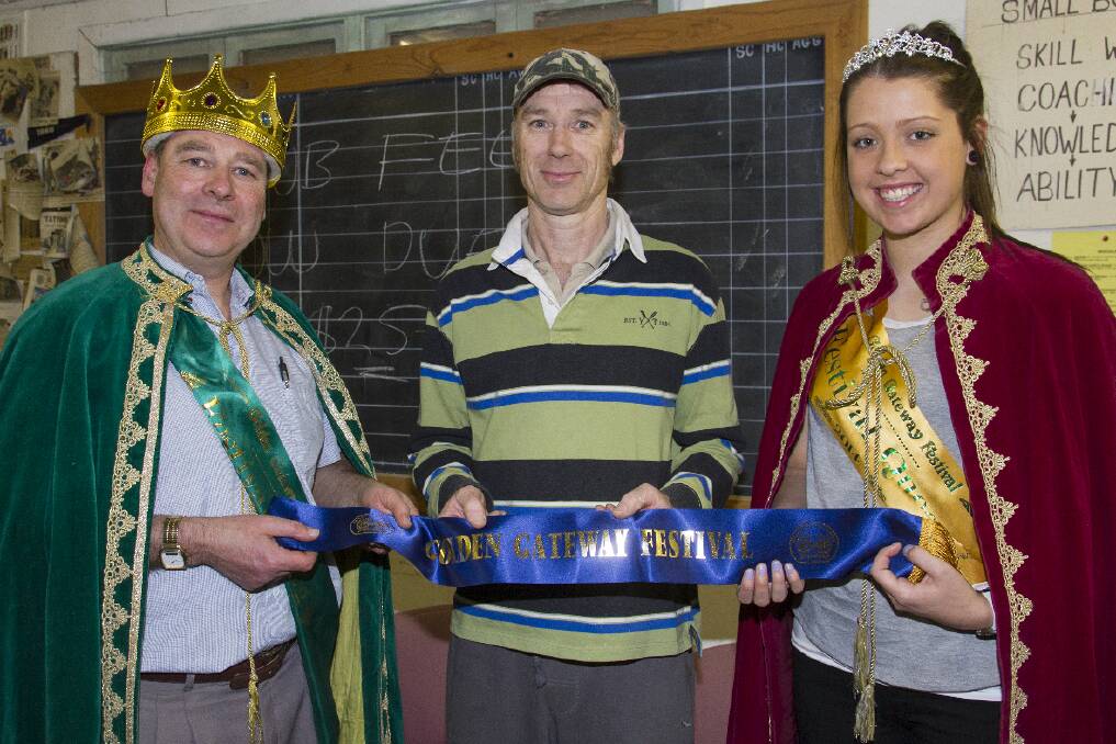 Golden Gateway Festival shoot winner Gary Brumby (centre) receives his sash from 2014 King Derek Pope and Queen Meg White. Pictures: PETER PICKERING