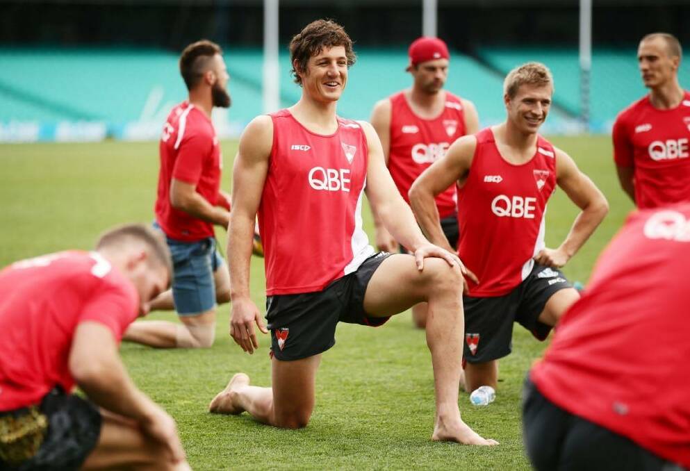 Bend, don't break: Kurt Tippett (centre) at a Swans recovery session. Photo: Matt King/Getty Images
