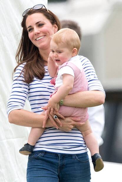 Prince George was snapped taking his first public walk with mum Catherine at a charity polo match on June 15.