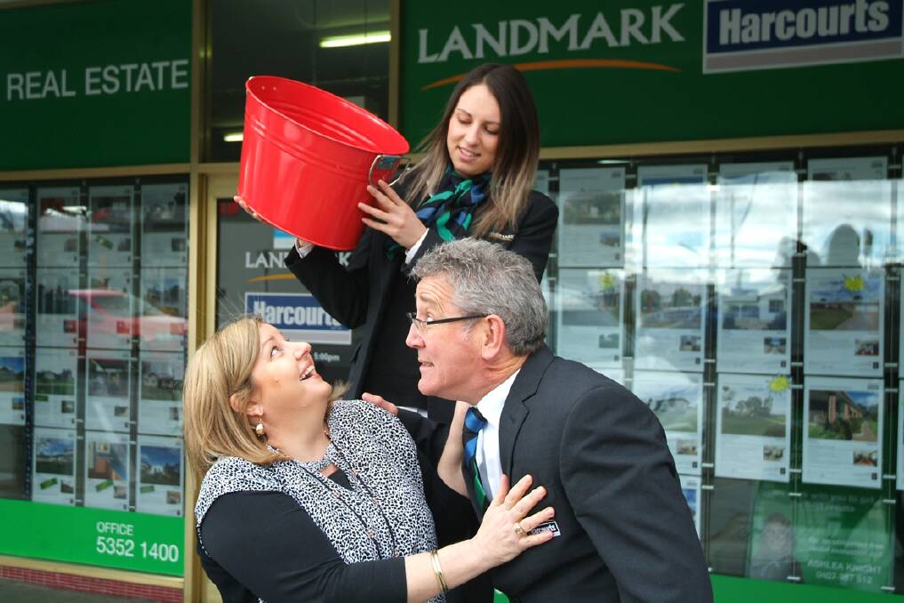 Kim and Greg Kerr prepare for a dousing of ice cold water by Ashlea Knight - all in a good cause, raising funds and awareness for Motor Neurone Disease. Picture: BEN KIMBER