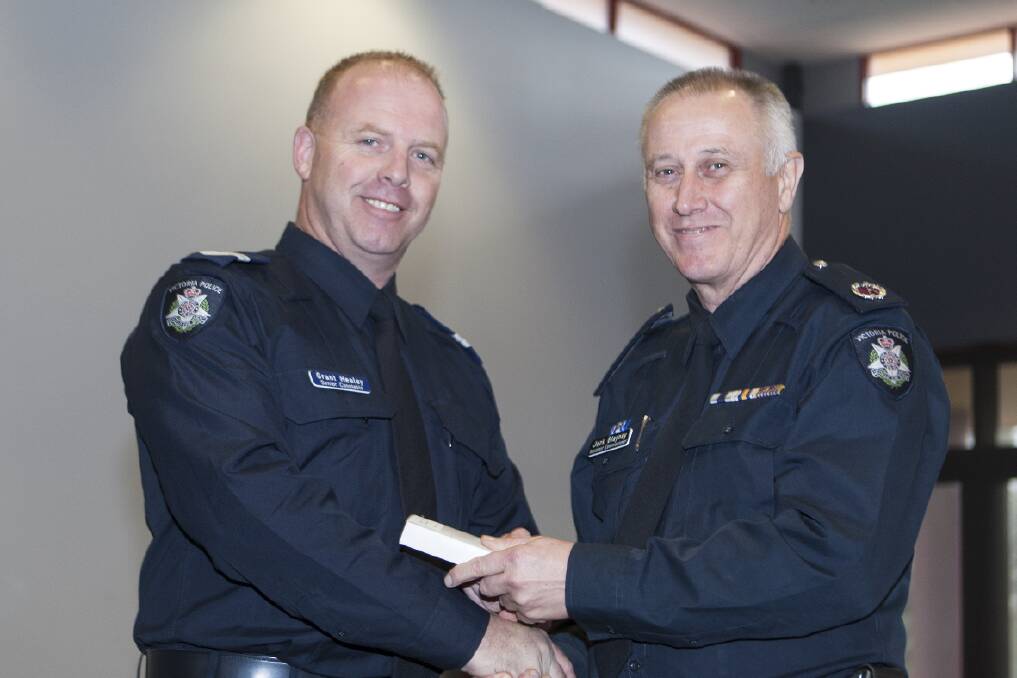 Grant Healey receives his ten year medal from Assistant Commissioner Jack Blayney