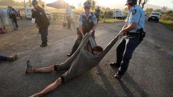 An anti-CSG protester is dragged away near AGL's proposed gas field near Gloucester, last year. Photo: Dean Sewell