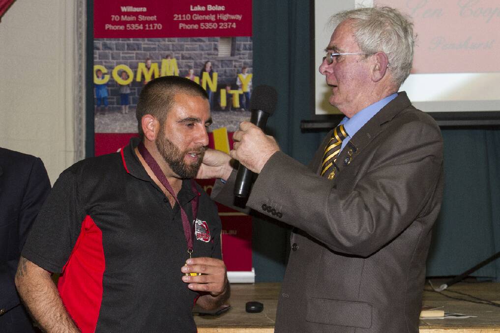 Len Cooper receives the reserves best and fairest medal from sponsor
David Martin.