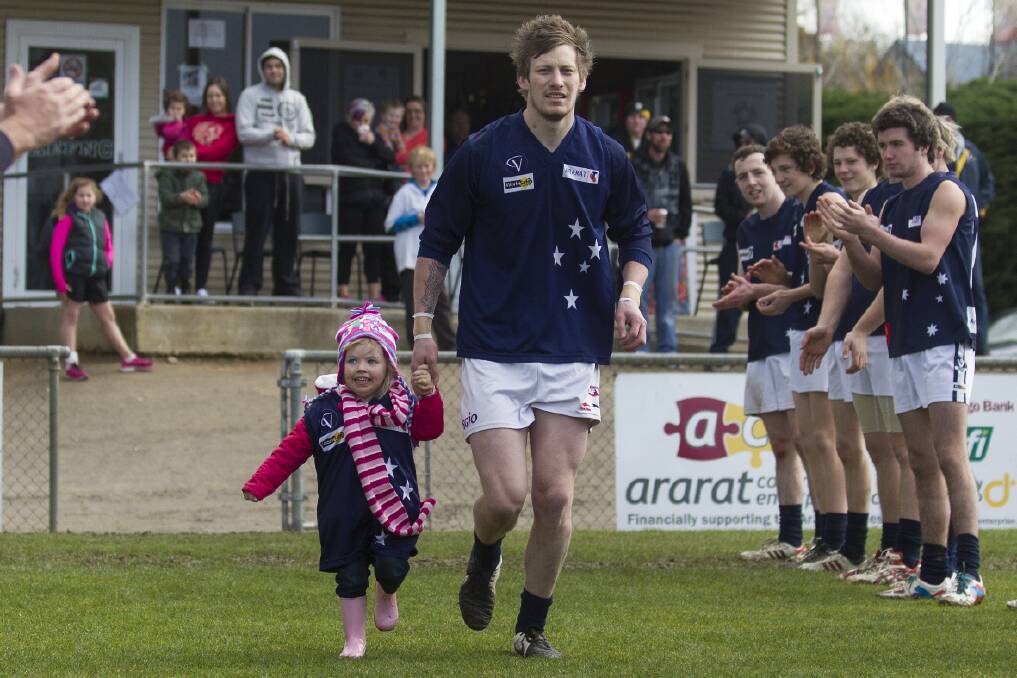 A guard of honour was formed as Nick Bulger ran out for his 100th senior game with niece Ruby last weekend. Pictures: PETER PICKERING