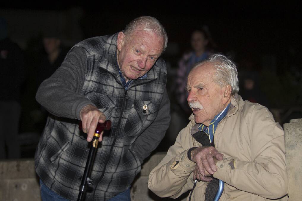 Max Schulz catches up with World War II veteran Don Smith at the Dawn Service. 
 Pictures: PETER PICKERING