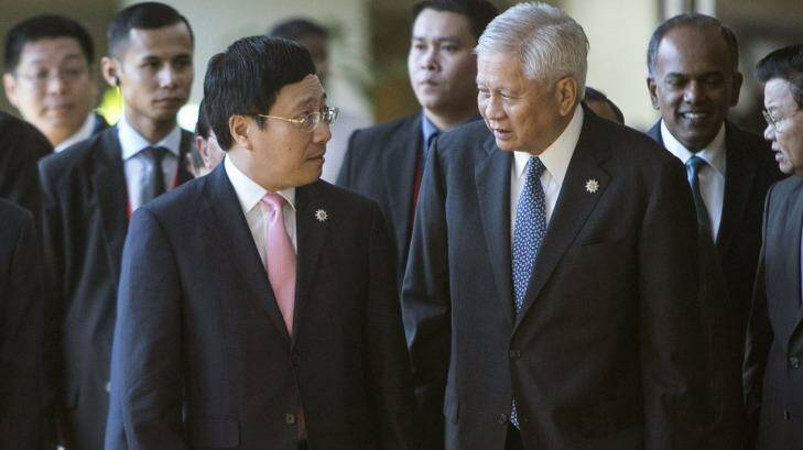 Philippines Foreign Secretary Albert del Rosario, right,  chats with Vietnam's Foreign Minister Pham Binh Minh as they arrive for the 26th ASEAN Summit. Photo: Joshua Paul