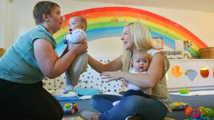 Samantha Swann with twins Jason and Isabella, helped by Julie at Tweddle Child and Family Health Service. Photo: Joe Armao