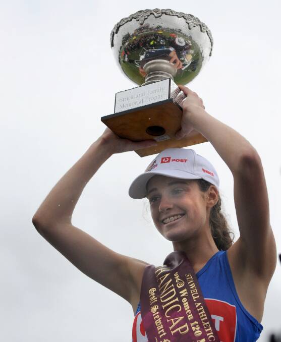 CHAMPION WOMAN: Grace O’Dwyer with the trophy following her victory in the Stawell Women’s Gift in 2015. She was just 15. Pictures: SAMANTHA CAMARRI
