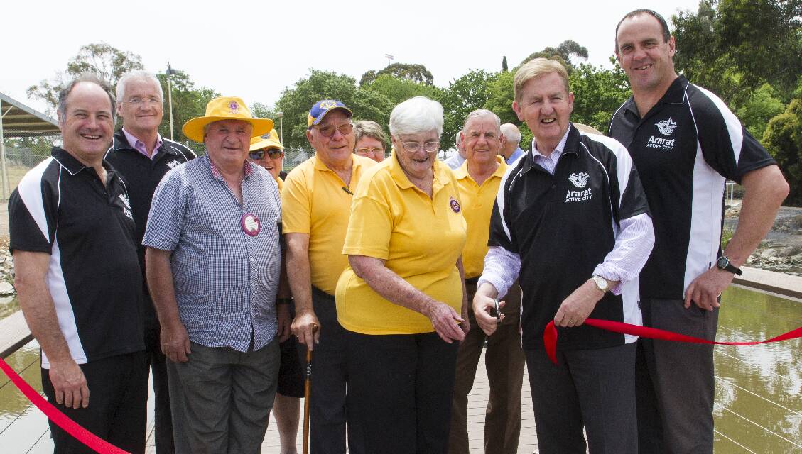 Val Tosch and Deputy Premier Peter Ryan cut the ribbon to open the new walking path at Alexandra Gardens, watched by Ararat Rural City Mayor Cr Paul Hooper, Lions David Lowing, Norm Tosch and Mick Thornbury and Nationals candidate for Ripon Scott Turner. Pictures: PETER PICKERING