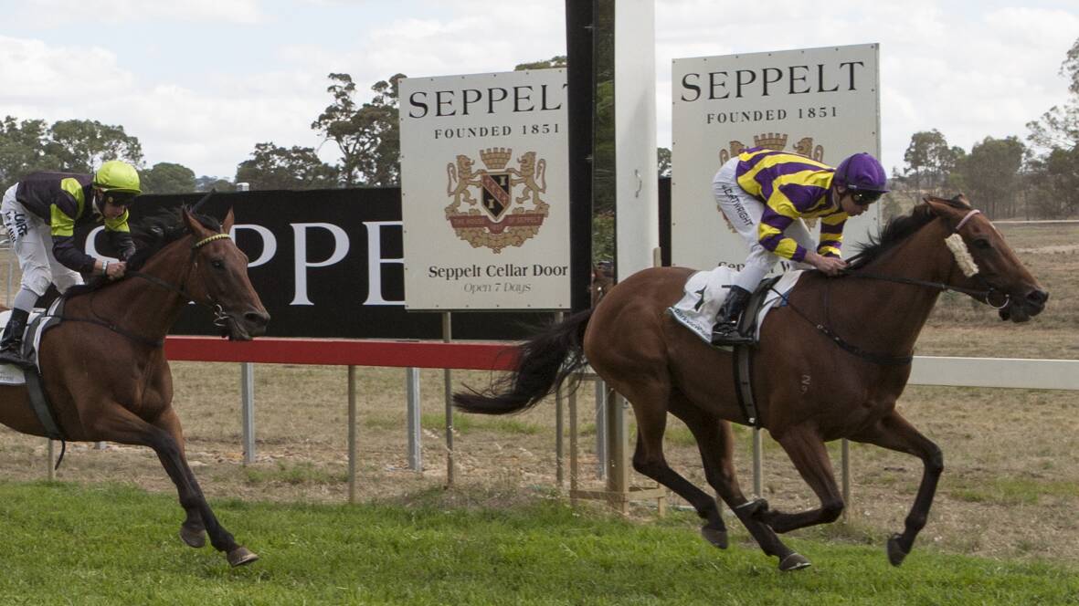 Jockey Josh Cartwright rides Warrnambool trained Jahan to victory at the 2015 Seppelt Salinger Great Western Cup, ahead of second place Beer Garden. Picture: PETER PICKERING