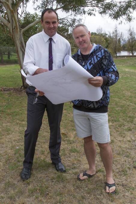Nationals candidate for Ripin, Scott Turner (left) and Ambrose Cashin go over the development plans for the Ararat Olympic Outdoor Swimming Pool. Picture: PETER PICKERING.