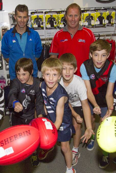 Marcus Cooper and Tim Shea with keen AusKick players Jim, Wilbur, Henry and
Luke. Picture: PETER PICKERING.