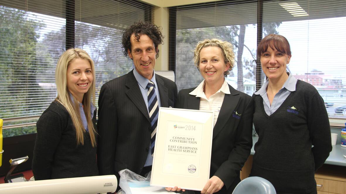 Claire Homburg, East Grampians Health Service CEO Nick Bush, Anna Greene and Rachael Cooper with the award for the Happy Mouths Happy Kids initiative.