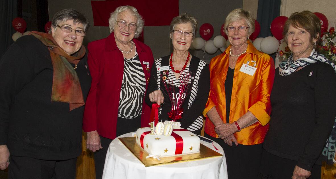 Glenda Davis, Edith Atkinson, Lake Bolac Red Cross chair Careen Keyte, vice chair Lynne Hucker and secretary Lorraine Hogan gather around the 100th anniversary cake. Picture: PETER PICKERING