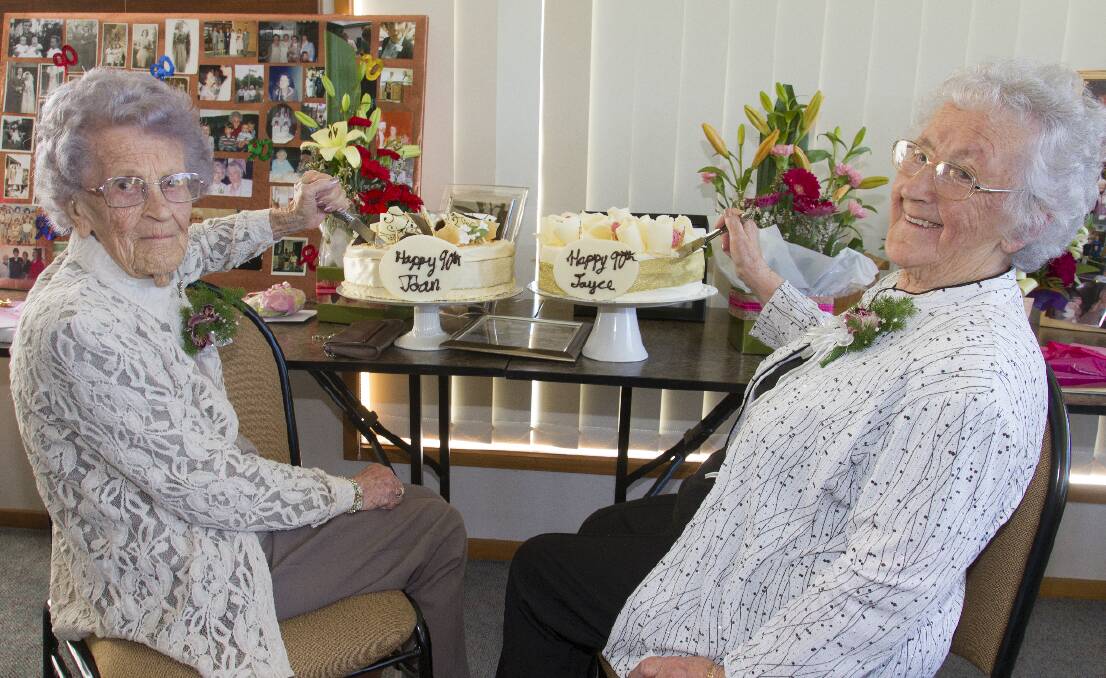 Twin birthday girls Joan Smart and Joyce Hellyer celebrated their 90th birthdays together, as they have done since they were 50, and were joined by family and friends at the Ararat Bowls Club. The ladies are pictured each cutting their own birthday cake. Picture: PETER PICKERING