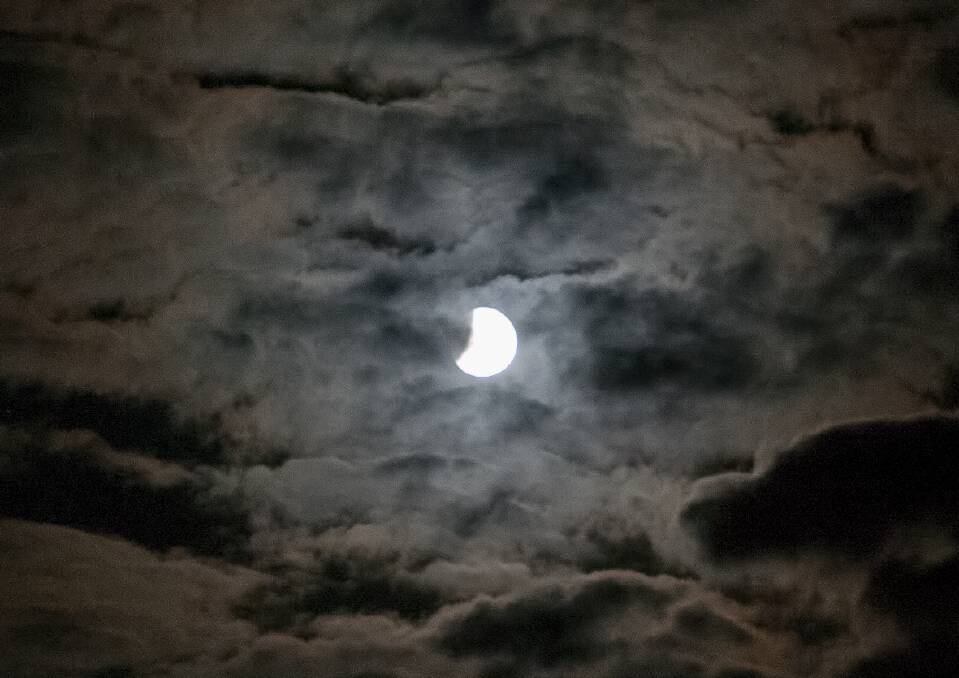Unfortunately for most people across our region the moon appeared void of any red and was at times obscured by heavy cloud. Picture: PETER PICKERING 
