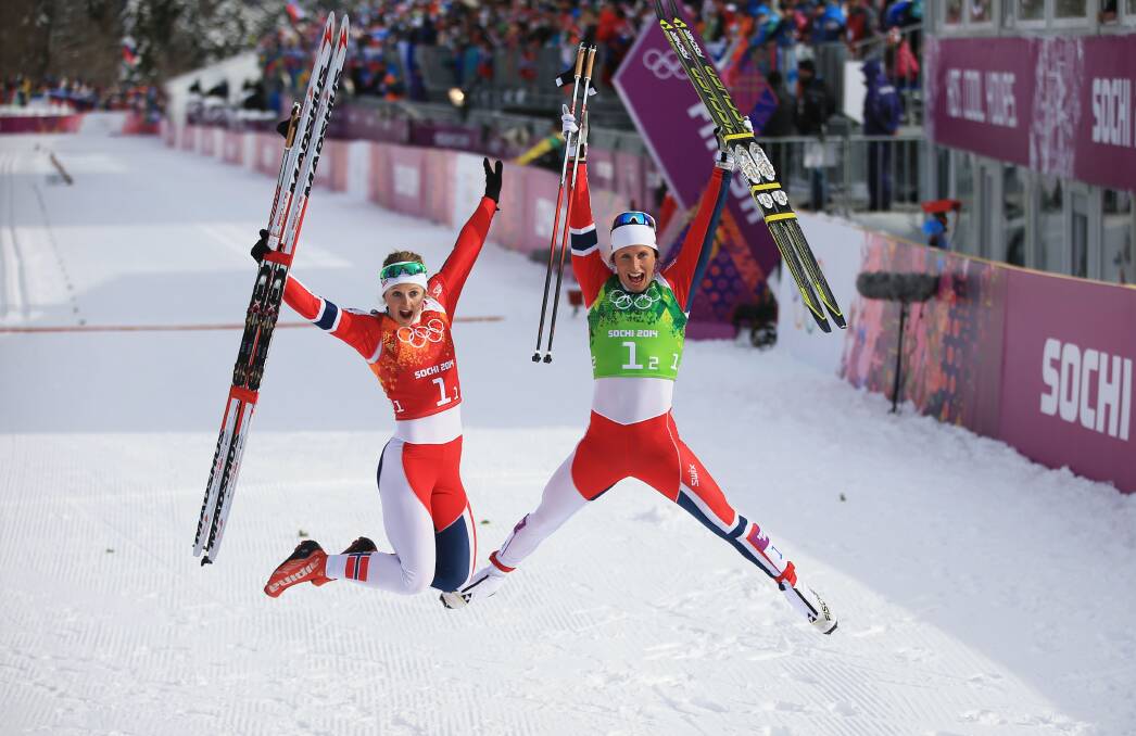 Gold medalists Marit Bjoergen (R) of Norway and Ingvild Flugstad Oestberg of Norway celebrate after the Women's Team Sprint Classic Final during day 12 of the 2014 Sochi Winter Olympics at Laura Cross-country Ski & Biathlon Center on February 19, 2014 in Sochi, Russia. Photo: GETTY IMAGES
