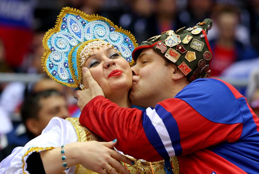 Russian fans kiss during the Men's Ice Hockey Quarterfinal Playoff between Finland and Russia on Day 12 of the 2014 Sochi Winter Olympics at Bolshoy Ice Dome on February 19, 2014 in Sochi, Russia. Photo: GETTY IMAGES