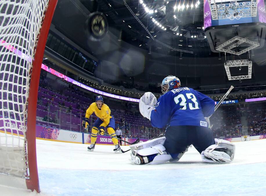 Loui Eriksson #21 of Sweden shoots and scores against Robert Kristan #33 of Slovenia in the third period during the Men's Ice Hockey Quarterfinal Playoff on Day 12 of the 2014 Sochi Winter Olympics at Bolshoy Ice Dome on February 19, 2014 in Sochi, Russia. Photo: GETTY IMAGES