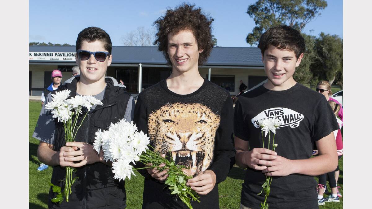 Volunteers Jack, Charlie and Jake handed out chrysanthemums.