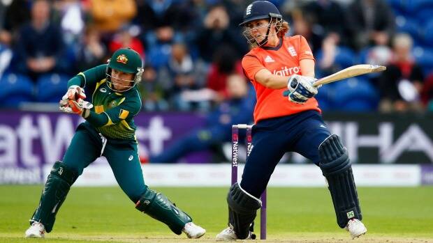 Player of the match, Natalie Sciver of England, cuts as Australian wicketkeeper Alyssa Healy looks on. Photo: Getty Images