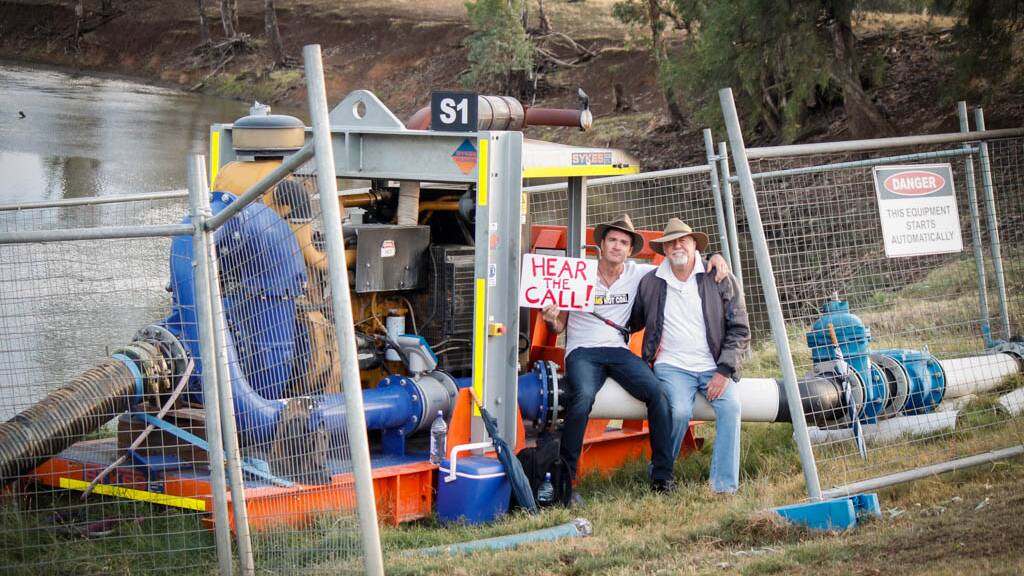TAKING A STAND: Country music superstar Luke O'Shea and his father, Rick, are locked on to a pump drawing water from the Namoi River to wash coal.