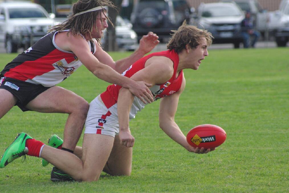Liam Cavanagh gets the ball away while under pressure during last week's victory over the Horsham Saints.