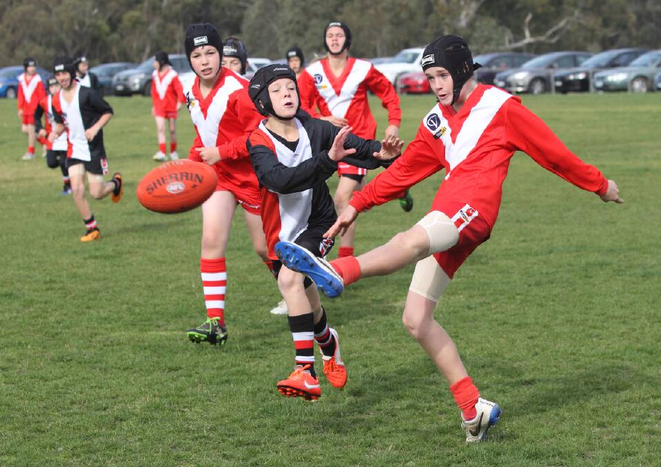 Mounties’ under-13 player Matthew gets his kick away while under pressure during the Ararat and District Junior Football Association clash against Warriors. Picture: PETER PICKERING