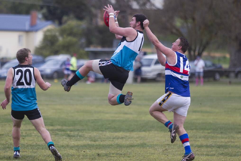 Moyston/Willaura forward Lachie Hamilton leaps at the ball ahead of opponent Daniel Mengler from SM&W Rovers. Hamilton had a day out on Saturday booting nine goals to lead the Pumas to a comfortable 73-point victory. Picture: PETER PICKERING