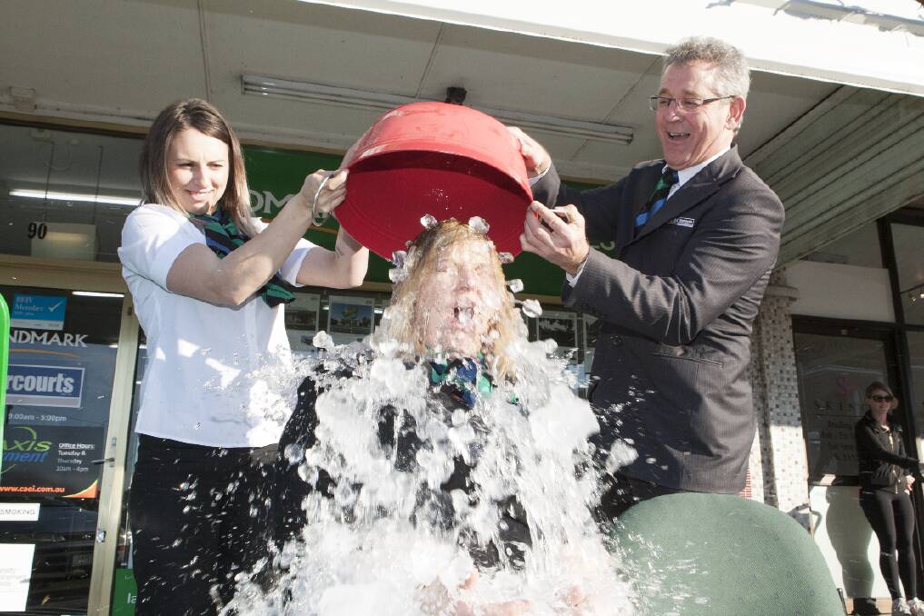 The Landmark Harcourts’ team got behind Kim and Greg Kerr’s Ice Bucket Challenge on Wednesday, with Greg Kerr and Ashlea Knight pictured happily dumping a bucket of ice on Kim. Picture: PETER PICKERING