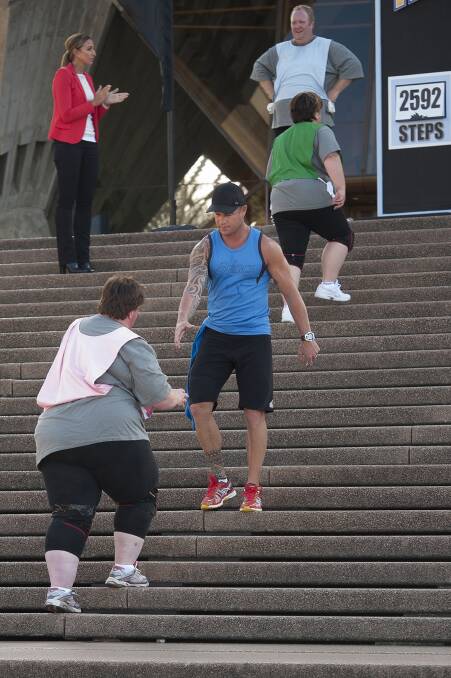 Shannan helps Mary during the Sydney Opera House steps challenge. Picture: CONTRIBUTED