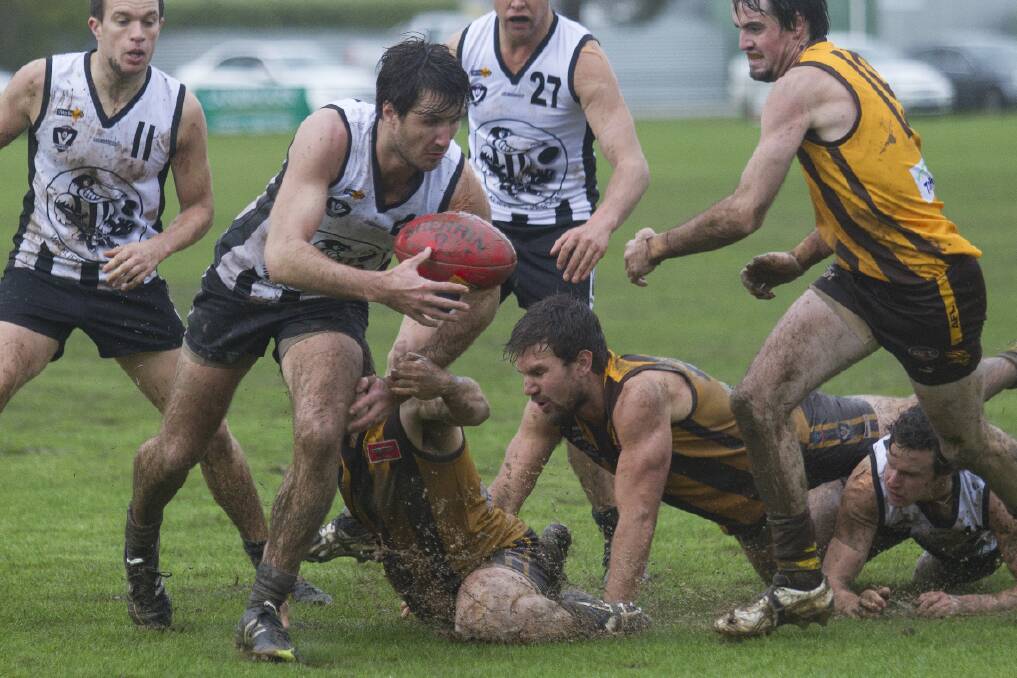 Wickliffe/Lake Bolac’s Michael Otto slips through his Hawks’ opponents during the wet weather clash at Tatyoon on Saturday. The Magpies handed the home team its first defeat of the season by 11 points.
