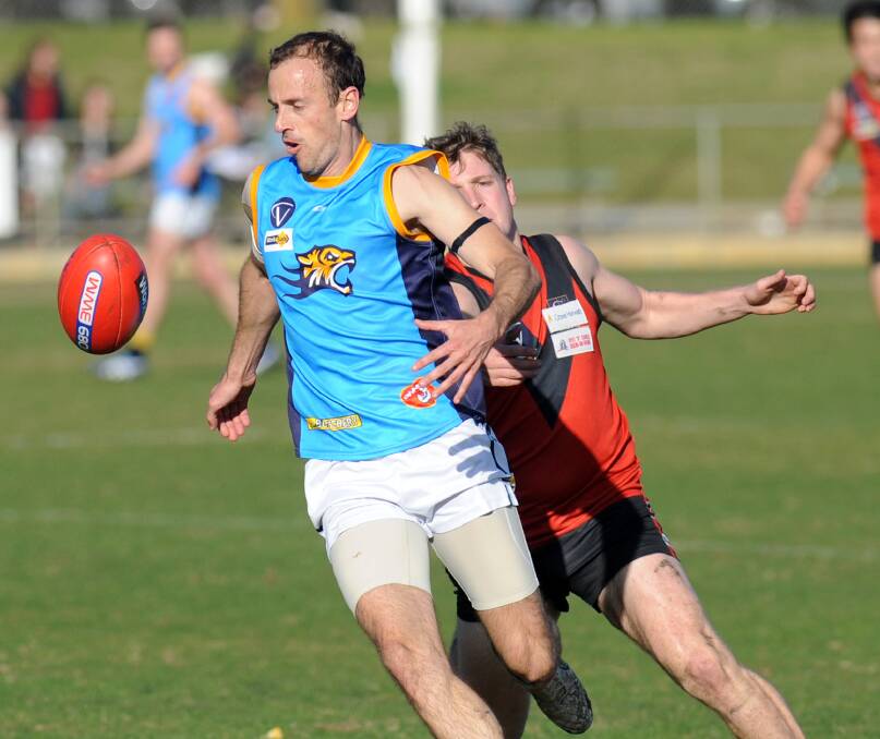 CHASE: Nhill's Wayne Batson leads Stawell's Jamie Bach to the ball in the round 13 clash. Both teams have an incentive to win. Picture: PAUL CARRACHER